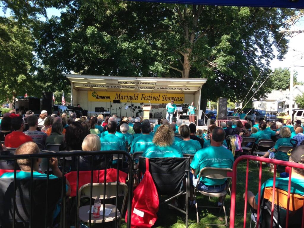 large crowd sitting and viewing the community worship service